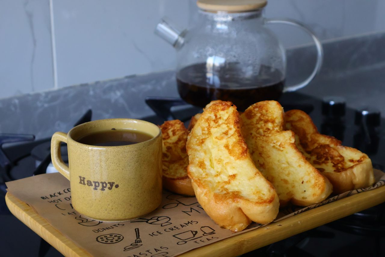 Home A cozy breakfast setup with French toast and coffee on a kitchen counter.