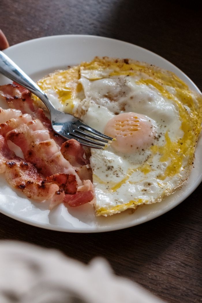 Offerings A hearty breakfast plate with fried eggs and crispy bacon, perfect start to the day.